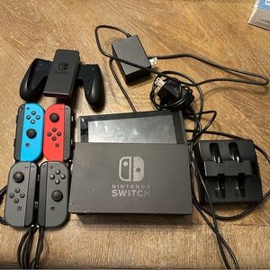Nintendo Switch with four controllers & charging station